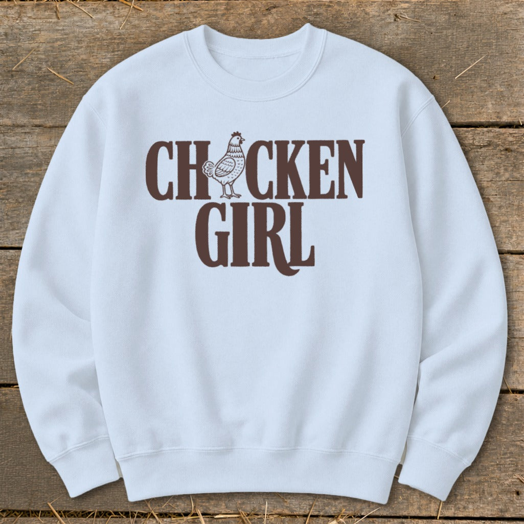 Light blue crewneck sweatshirt with brown "CHICKEN GIRL" text and chicken graphic.