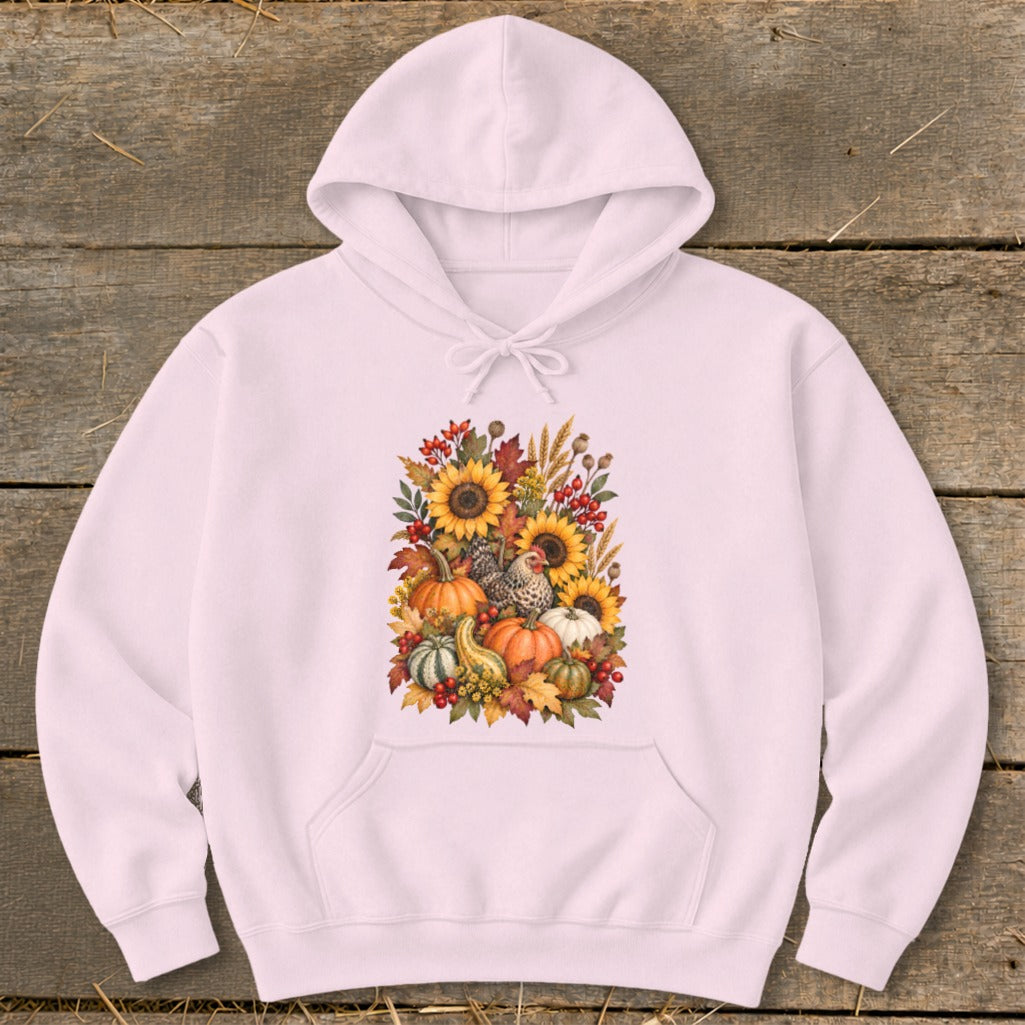 Pink hoodie with a fall harvest graphic featuring pumpkins, sunflowers, and chickens.