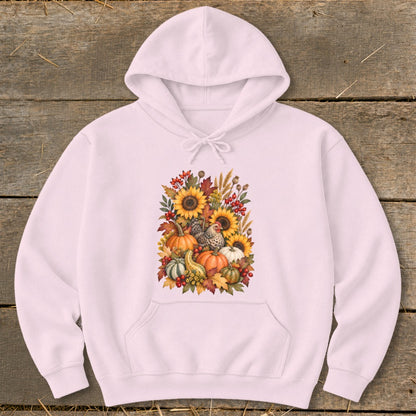 Pink hoodie with a fall harvest graphic featuring pumpkins, sunflowers, and chickens.