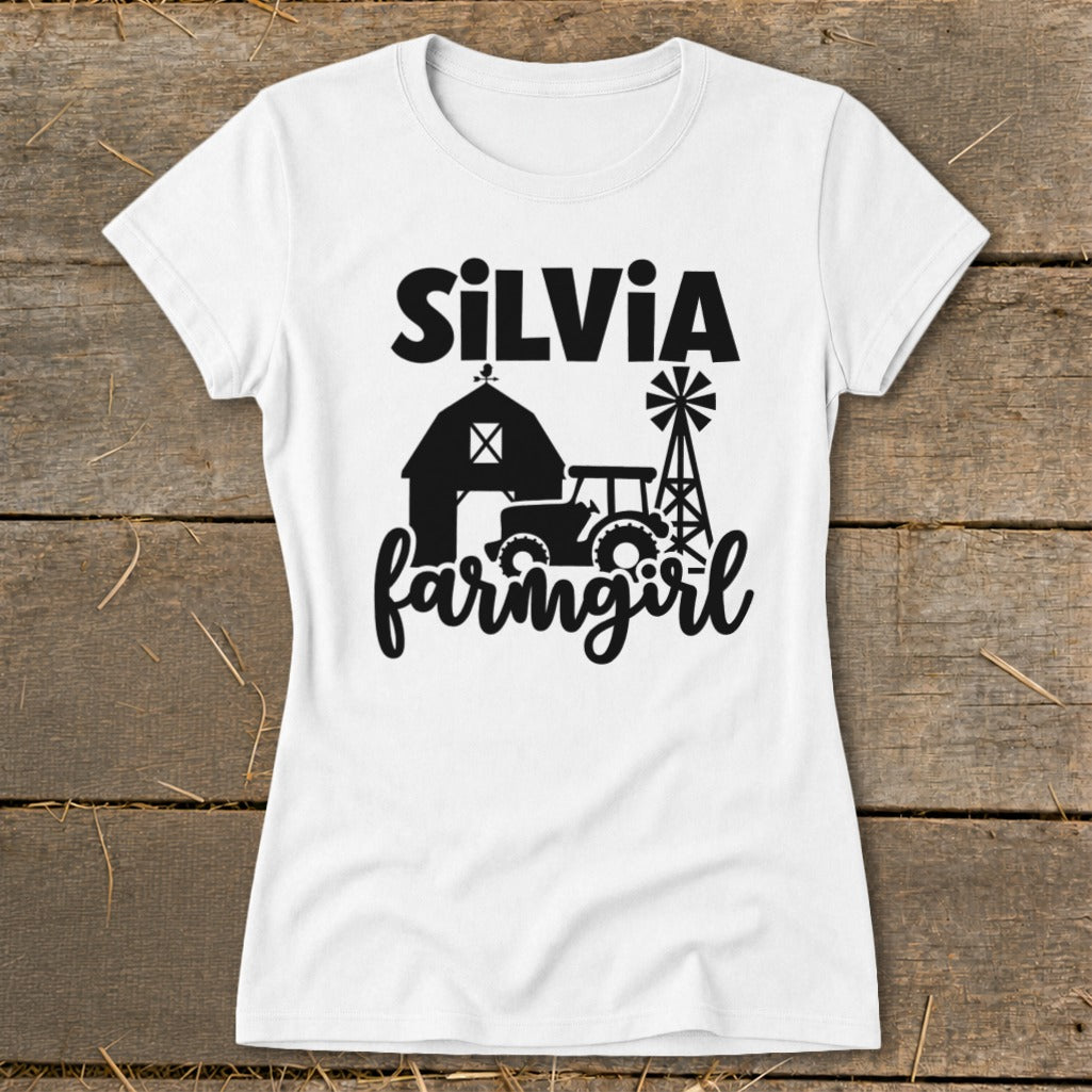 White t-shirt with "SiLVia" and "farmgirl" text and barn, tractor, windmill graphics.
