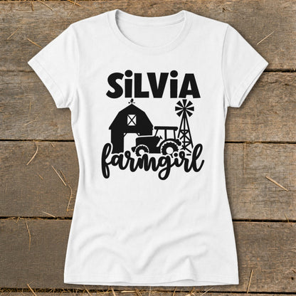 White t-shirt with "SiLVia" and "farmgirl" text and barn, tractor, windmill graphics.
