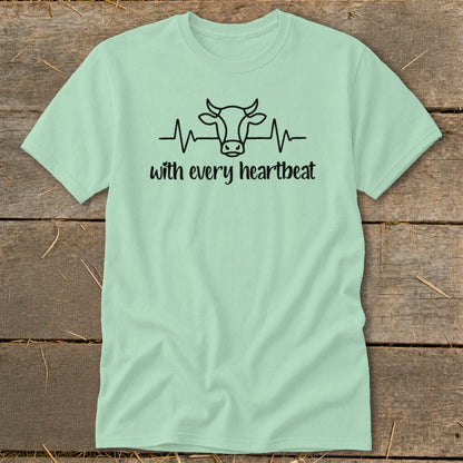 Light green t-shirt with black cow head and heartbeat graphic and text.
