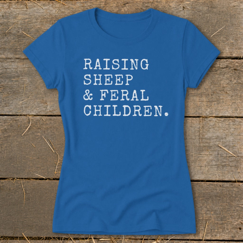 Blue t-shirt with white text "RAISING SHEEP & FERAL CHILDREN."