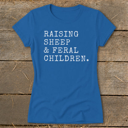 Blue t-shirt with white text "RAISING SHEEP & FERAL CHILDREN."