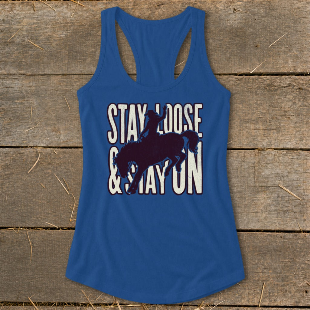 Blue racerback tank top with bucking bronco graphic and "STAY LOOSE & STAY ON" text.