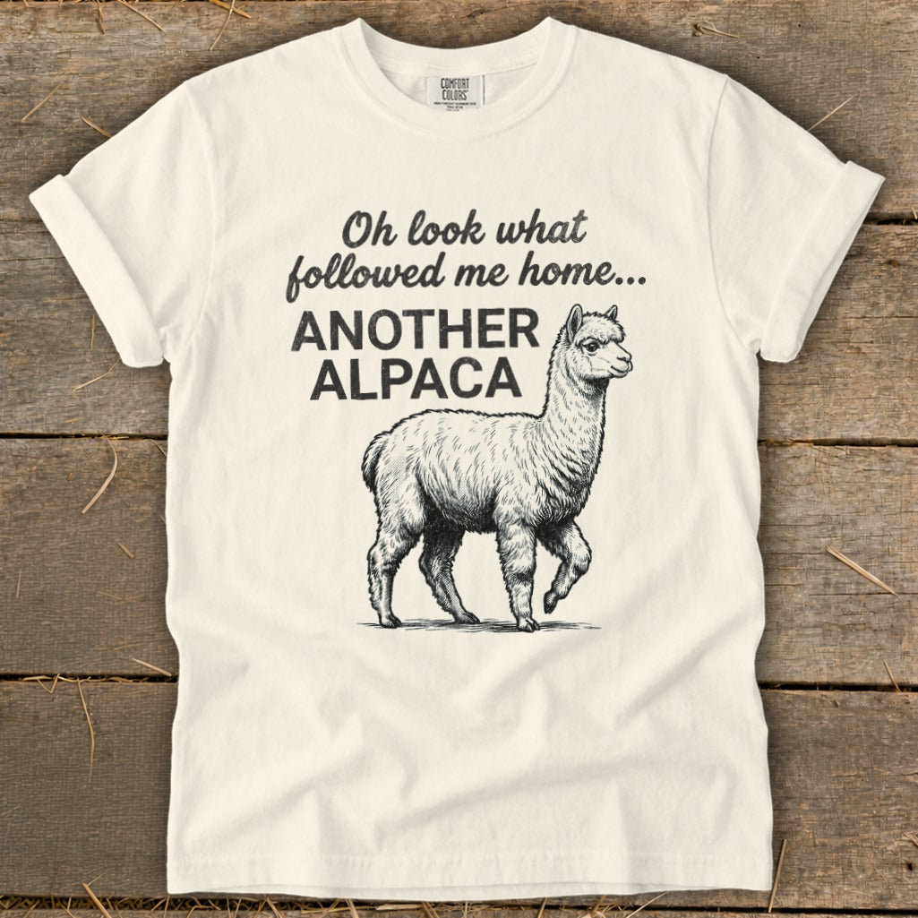 Cream t-shirt with "Oh look what followed me home... ANOTHER ALPACA" and an alpaca illustration.