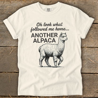 Cream t-shirt with "Oh look what followed me home... ANOTHER ALPACA" and an alpaca illustration.