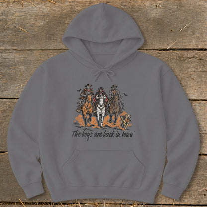 Three skeletal cowboys ride horses with a dog, text reads "The boys are back in town".