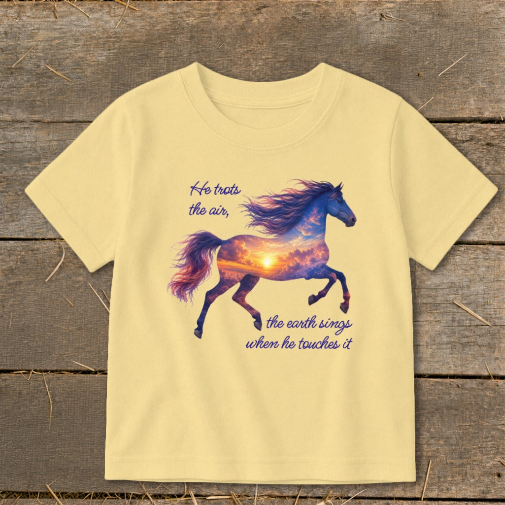 A pale yellow short-sleeved t-shirt features a galloping horse graphic filled with a sunset sky and inspirational text.