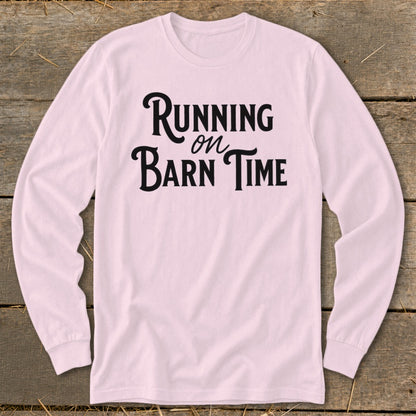 Pink long sleeve shirt with "Running on Barn Time" graphic text.