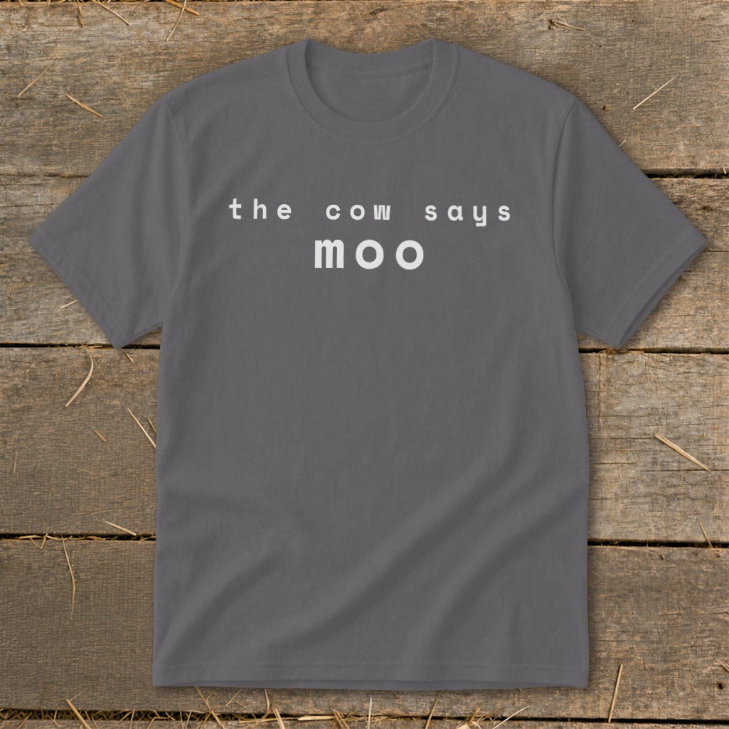 Gray t-shirt with white text "the cow says moo" on a wooden background.