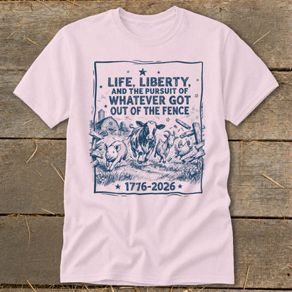 Pink t-shirt with farm animals escaping a fence and text "Life, Liberty, and the Pursuit of Whatever Got Out of the Fence 1776-2026".