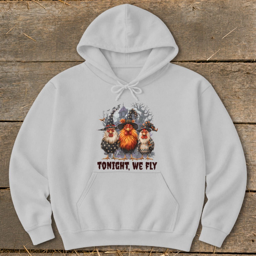 White hoodie with graphic of three chickens in witch hats and text "TONIGHT, WE FLY."
