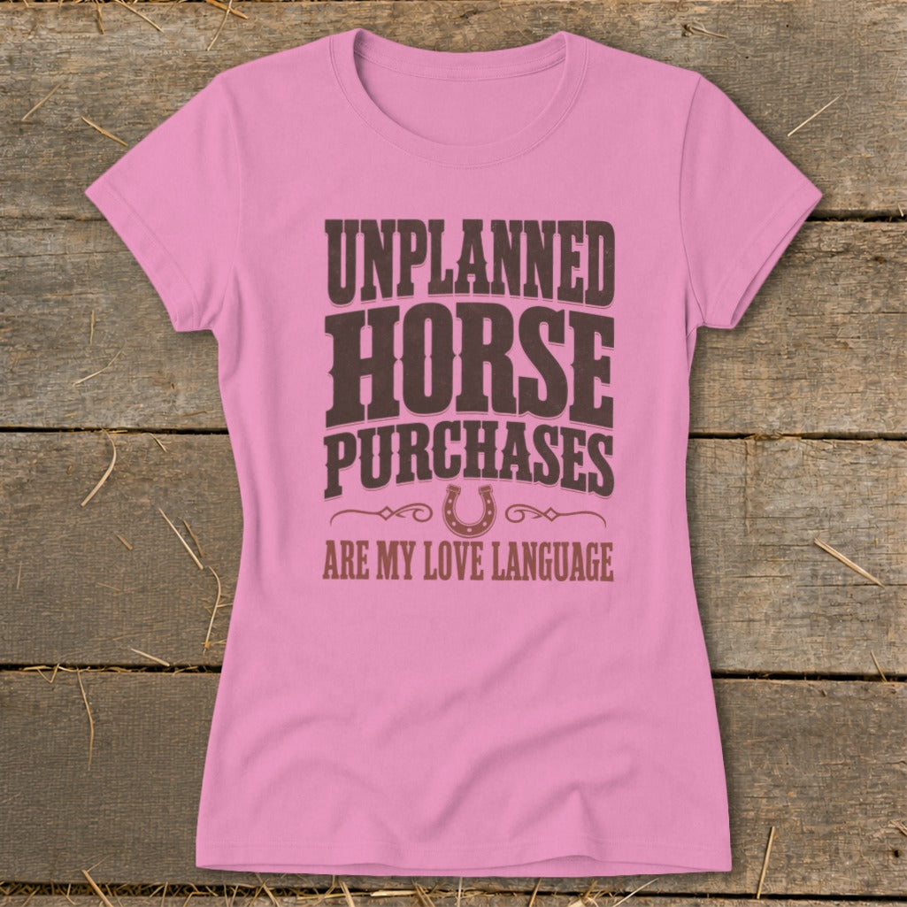 Pink t-shirt with "UNPLANNED HORSE PURCHASES ARE MY LOVE LANGUAGE" text and horseshoe.