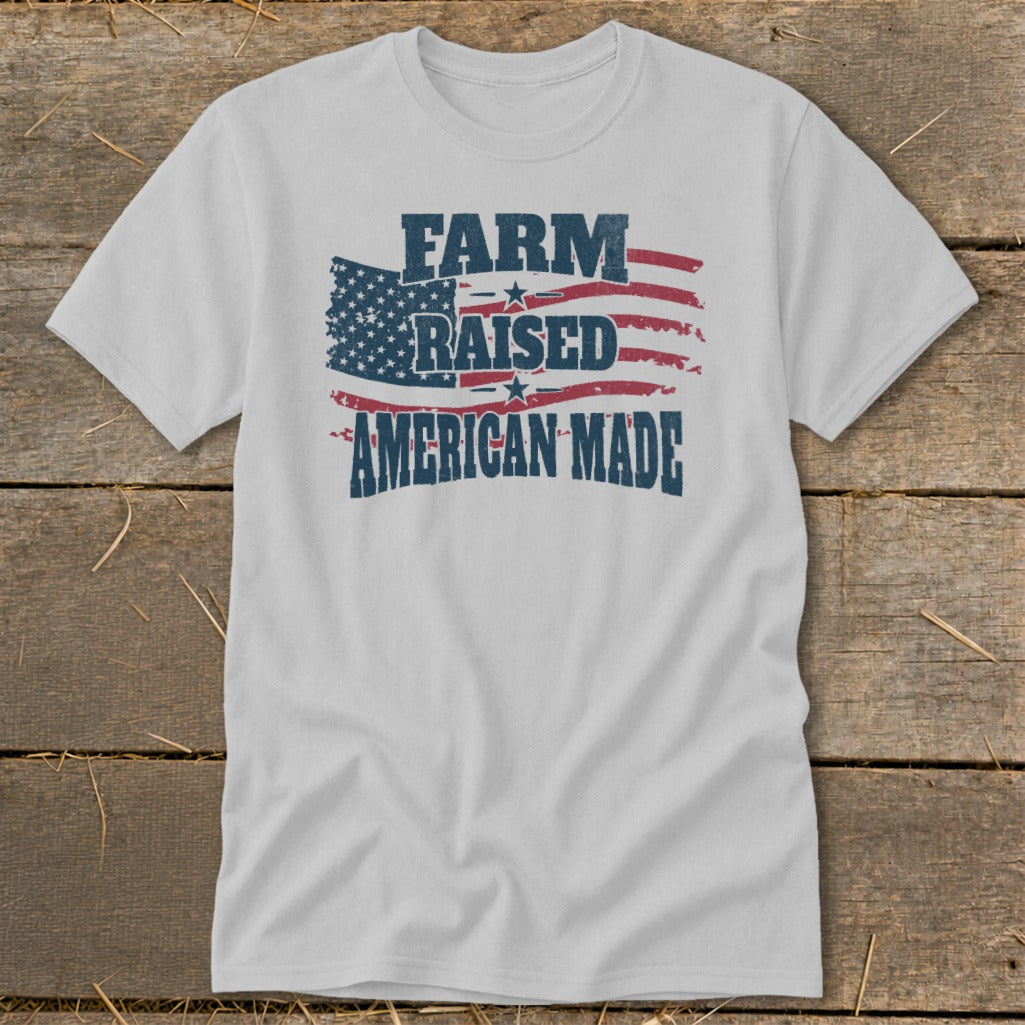 White t-shirt with distressed American flag graphic and text "FARM RAISED AMERICAN MADE".