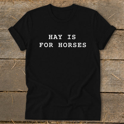 Black t-shirt with white text that reads "HAY IS FOR HORSES".