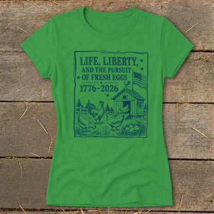 Green t-shirt with "Life, Liberty, and the Pursuit of Fresh Eggs 1776-2026" graphic.