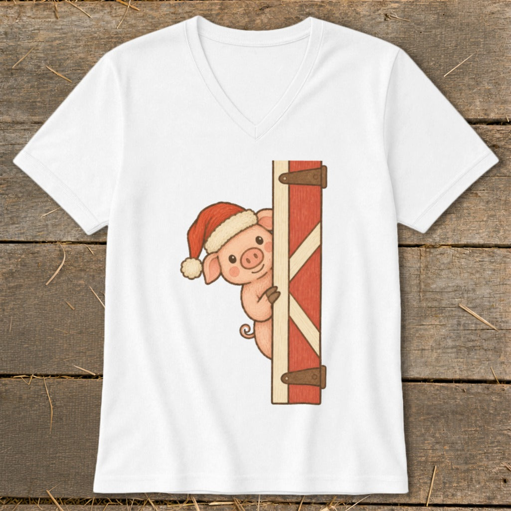 White v-neck t-shirt with a cartoon pig wearing a Santa hat peeking behind a red barn door.