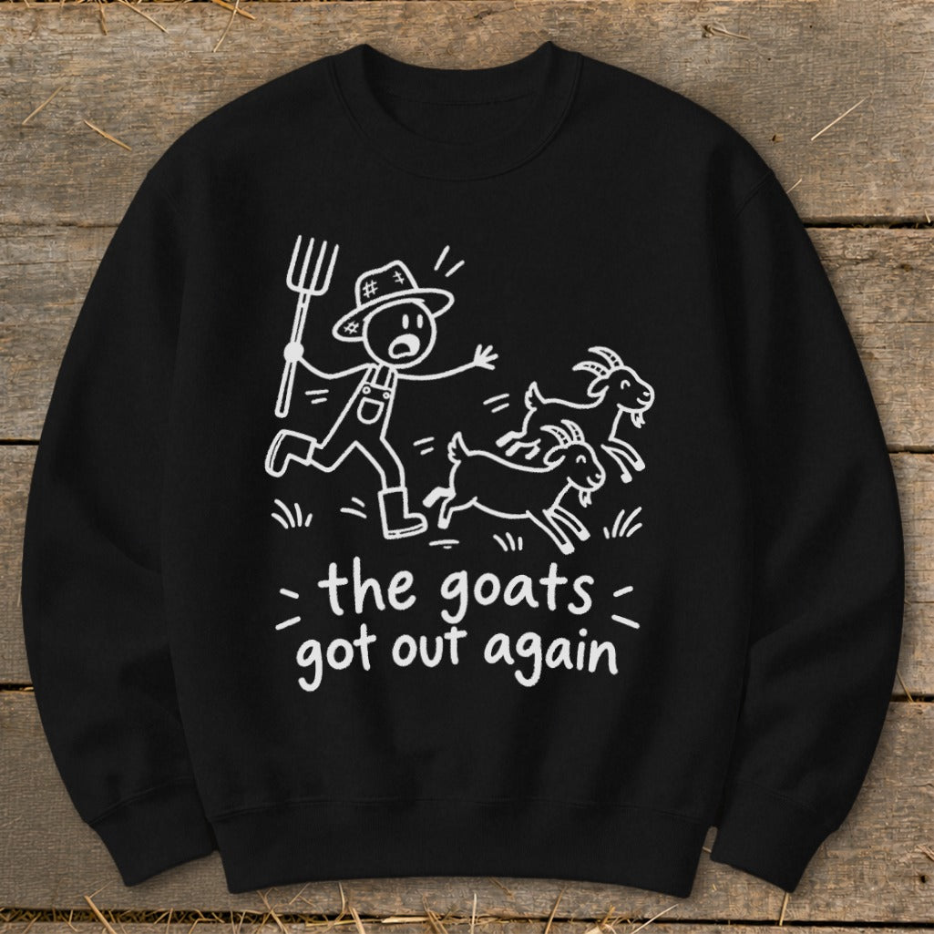 Black sweatshirt with white illustration of farmer chasing goats, text says "the goats got out again".