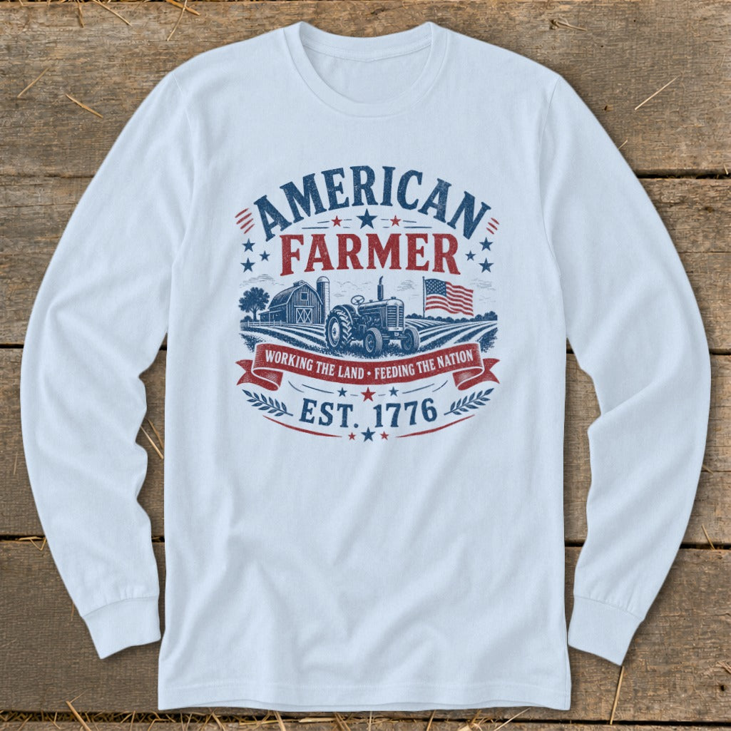 White long-sleeve shirt with "AMERICAN FARMER" graphic, tractor, barn, and American flag.