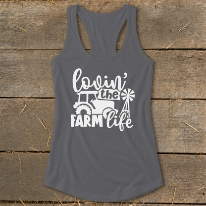 Gray tank top with white text and graphics reading "lovin' the farm life" with a tractor and windmill.
