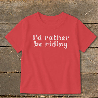 Coral t-shirt with white text that says "I'd rather be riding".