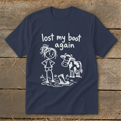 Navy blue t-shirt featuring a white graphic of a sad stick figure, a cow, and a muddy boot with the text "lost my boot again".