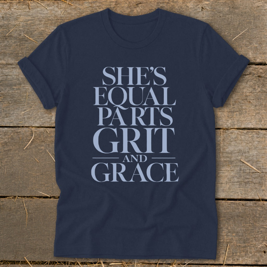 Dark navy t-shirt with text "SHE'S EQUAL PARTS GRIT AND GRACE"