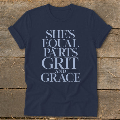 Dark navy t-shirt with text "SHE'S EQUAL PARTS GRIT AND GRACE"