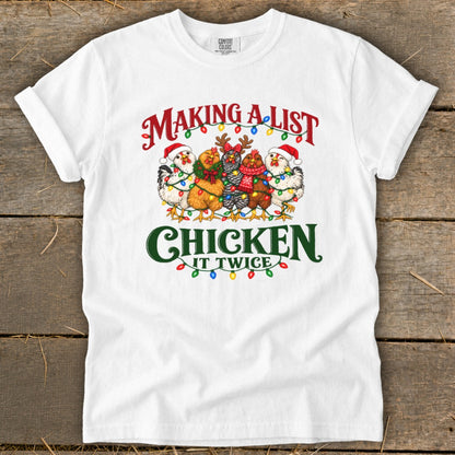 White t-shirt with "Making a list chicken it twice" text and festive chickens.