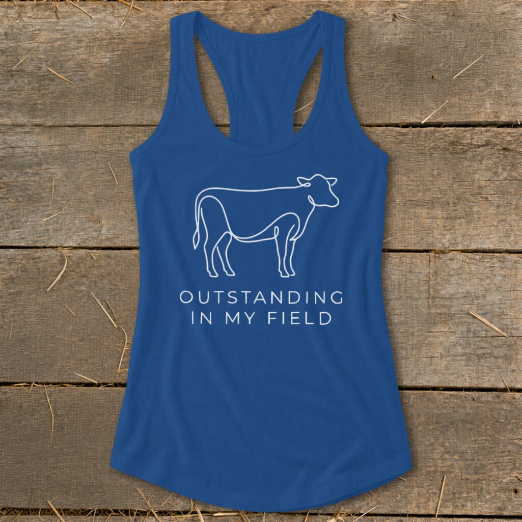 Blue tank top with white line drawing of a cow and text "OUTSTANDING IN MY FIELD".