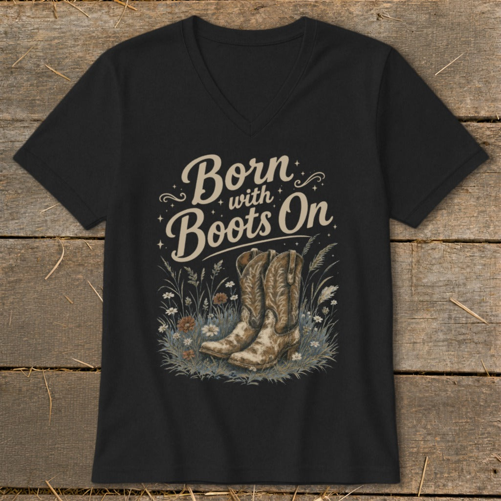 Black t-shirt with "Born with Boots On" text and cowboy boots in grass.