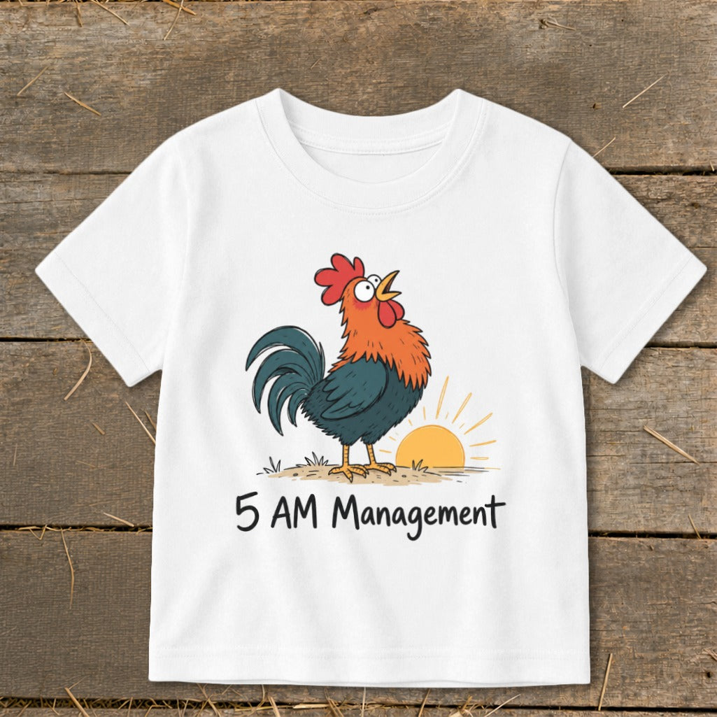 White t-shirt with a cartoon rooster crowing at sunrise and text "5 AM Management."