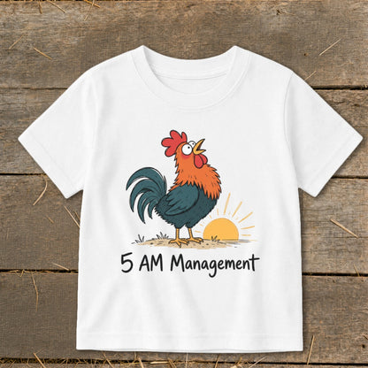 White t-shirt with a cartoon rooster crowing at sunrise and text "5 AM Management."