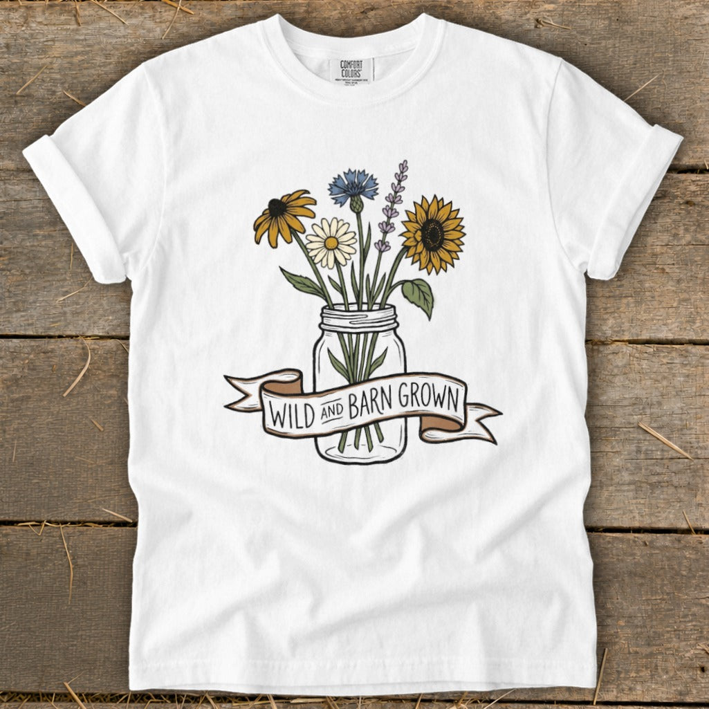 White t-shirt with a mason jar of wildflowers and "Wild and Barn Grown" banner.