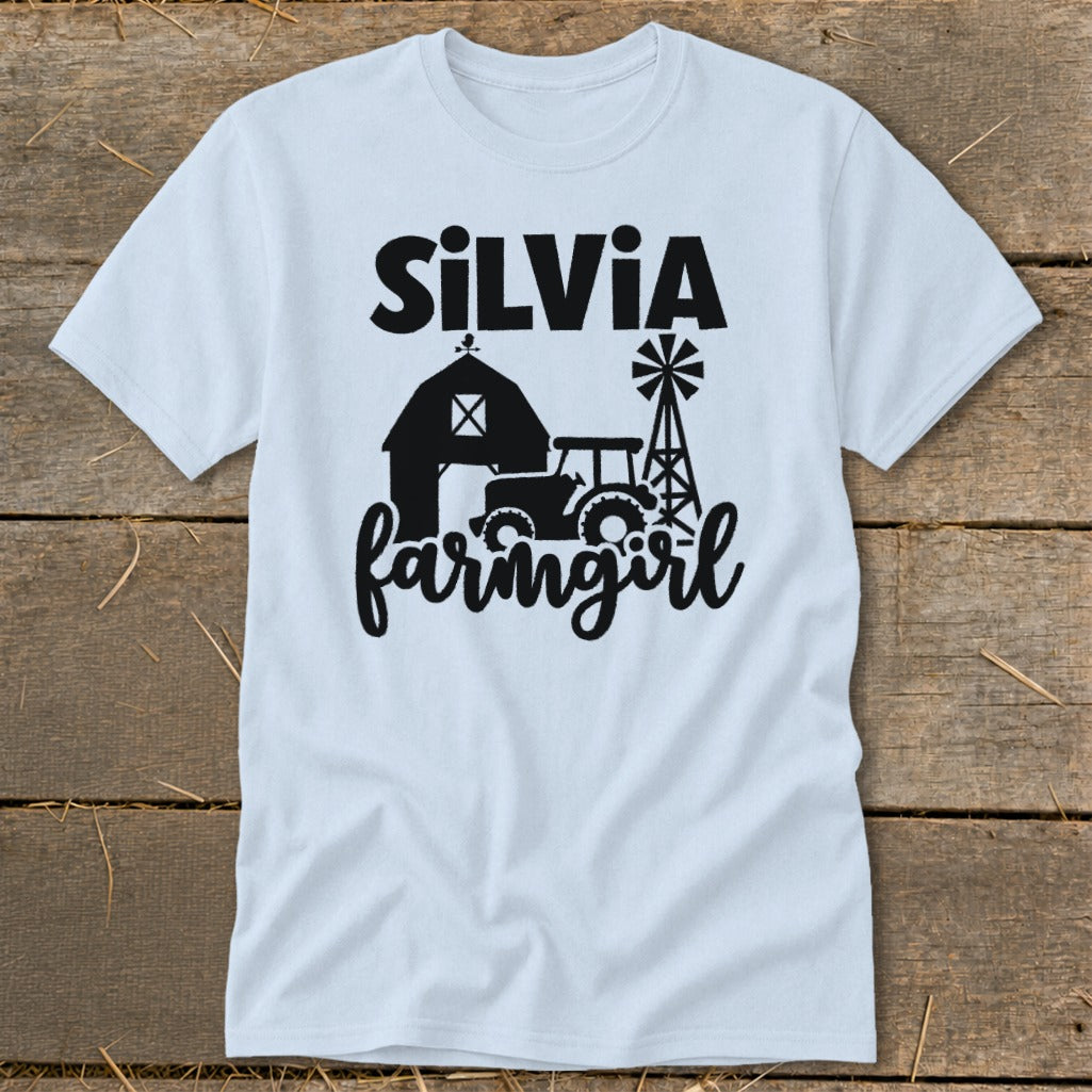 Light blue t-shirt with "Silvia farmgirl" text and barn, tractor, and windmill graphic.