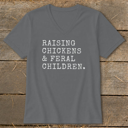 Grey v-neck t-shirt with white text "RAISING CHICKENS & FERAL CHILDREN."