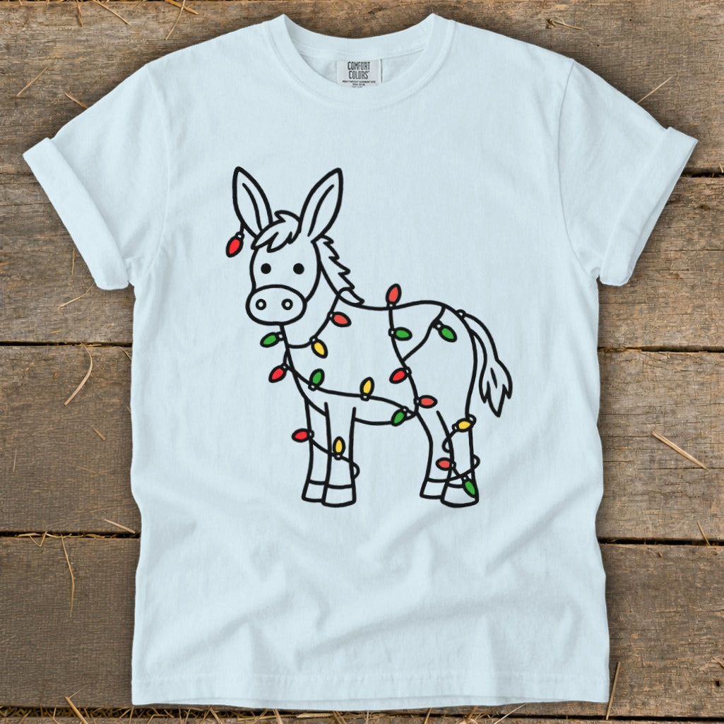 Light blue t-shirt with a cartoon donkey wrapped in colorful Christmas lights.