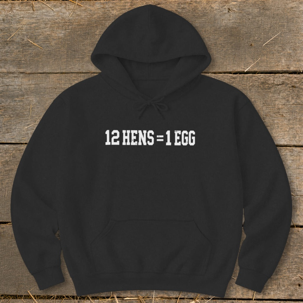 A black hooded sweatshirt featuring white text on the chest that reads 12 HENS = 1 EGG.