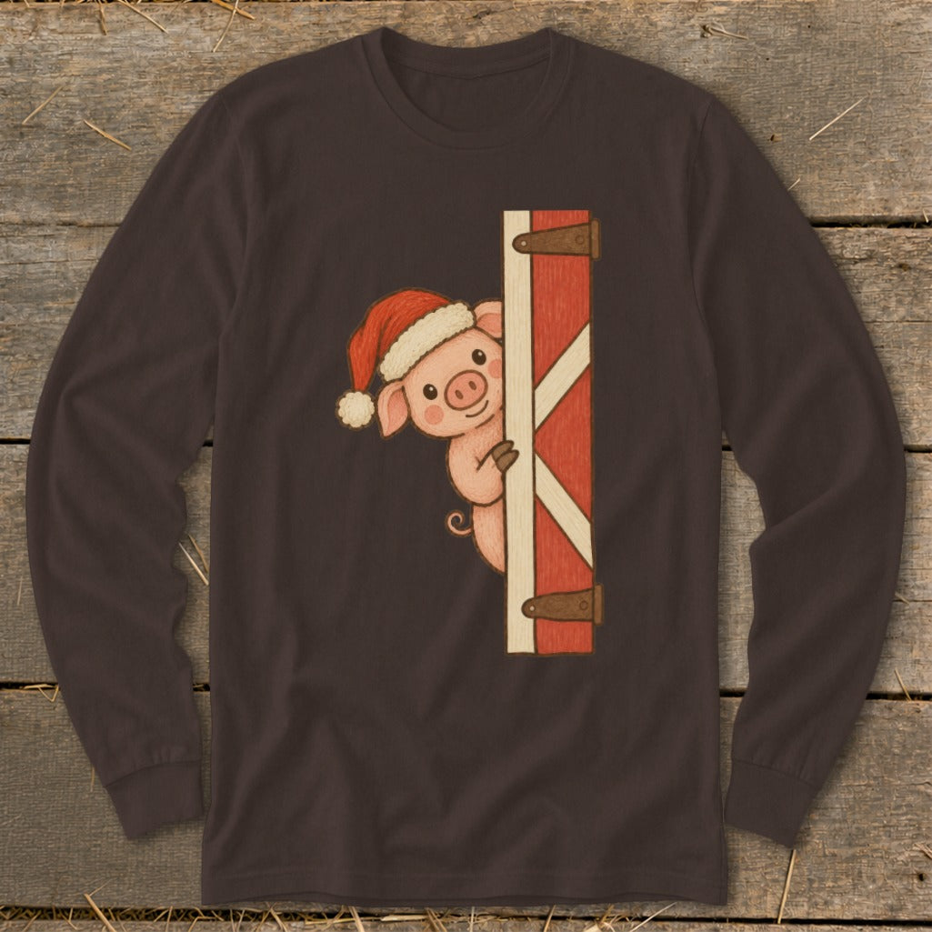 Cute pig wearing Santa hat peeks around a red barn door on a brown long-sleeve shirt.