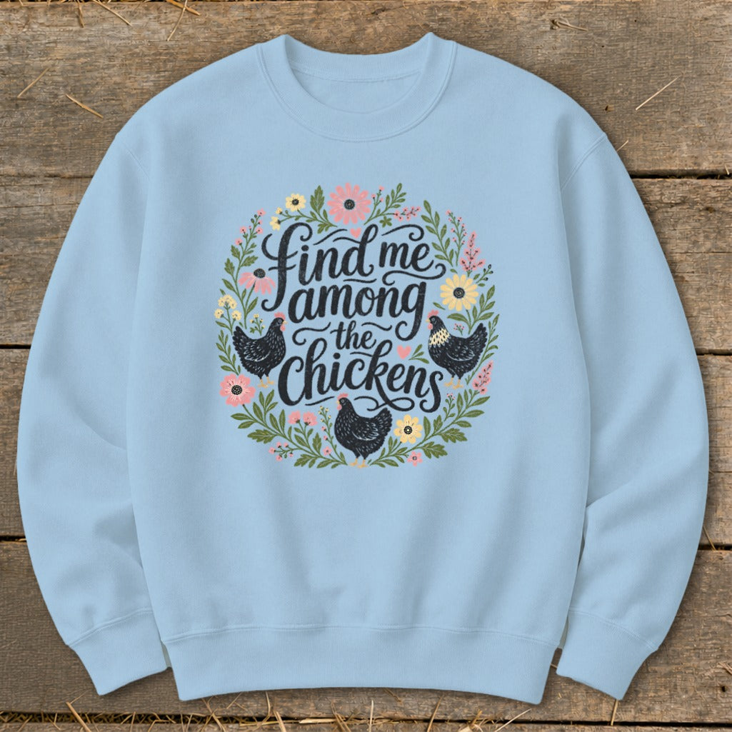Light blue crewneck sweatshirt with "Find me among the chickens" text and floral chicken design.