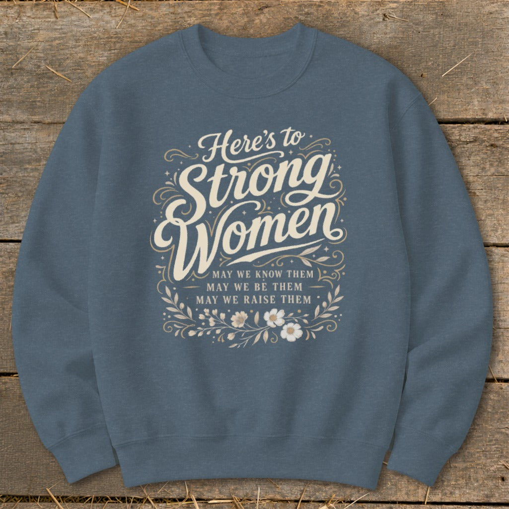Crewneck sweatshirt with "Here's to Strong Women" text and inspirational message.