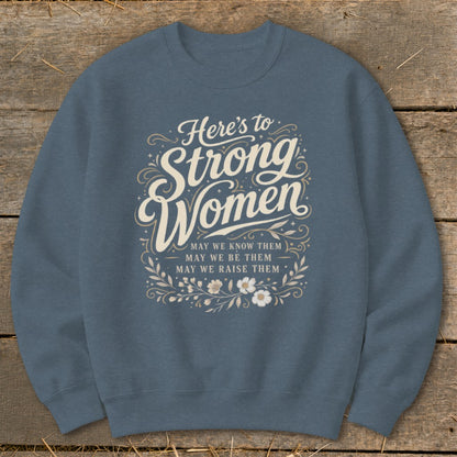 Crewneck sweatshirt with "Here's to Strong Women" text and inspirational message.