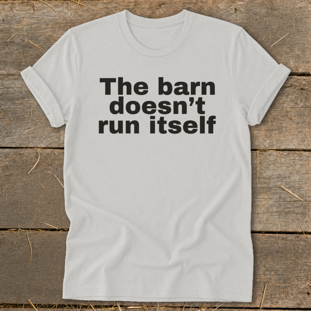 White t-shirt with black text reading "The barn doesn't run itself".