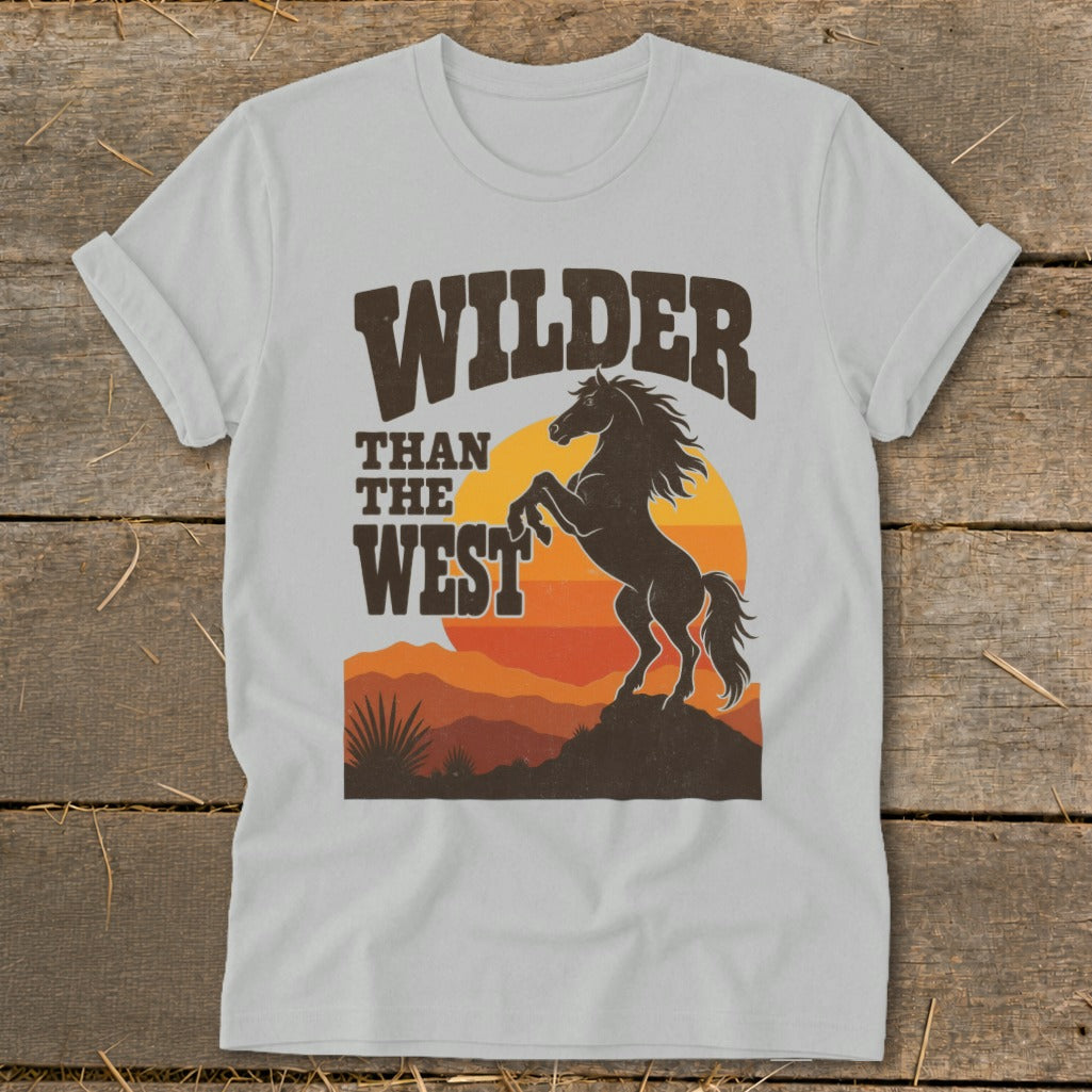 T-shirt graphic with "Wilder Than The West" text and a rearing horse silhouette.