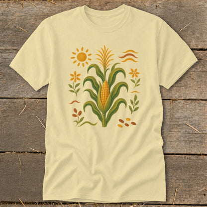 Pale yellow t-shirt with a corn stalk, sun, flowers, and leaves graphic.