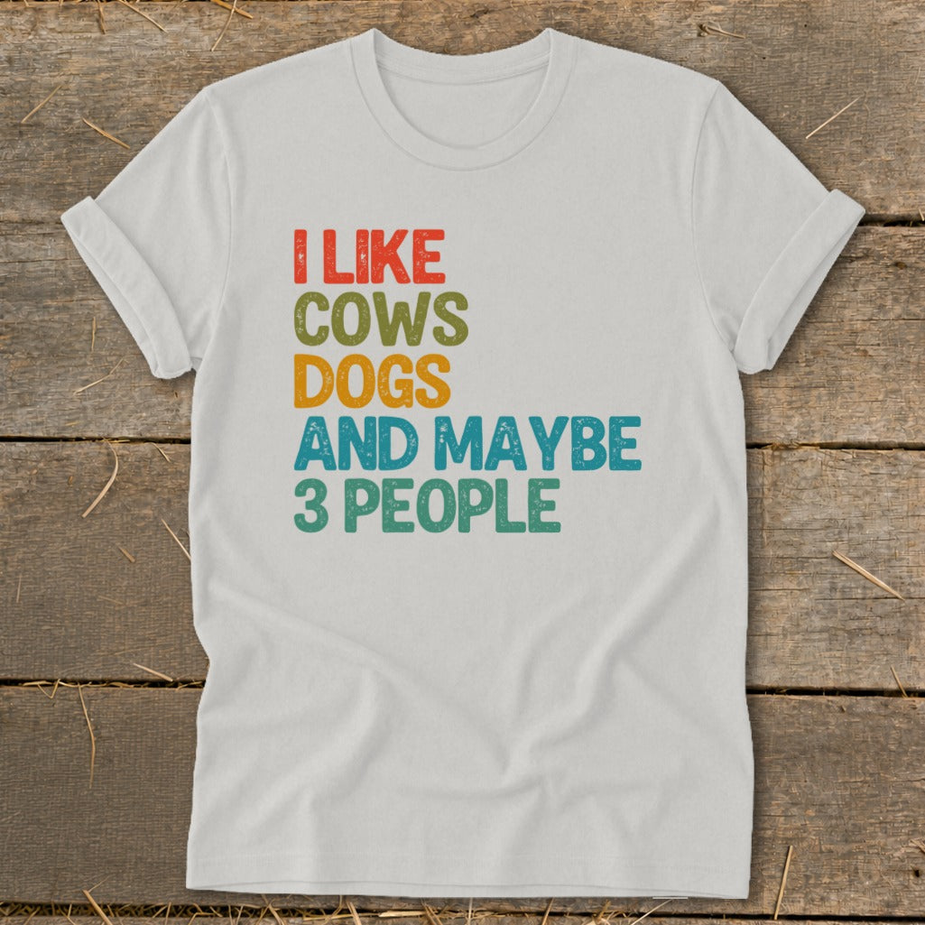 White t-shirt with text "I LIKE COWS DOGS AND MAYBE 3 PEOPLE".