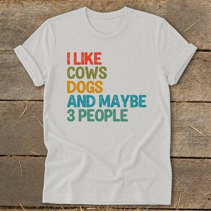 White t-shirt with text "I LIKE COWS DOGS AND MAYBE 3 PEOPLE".