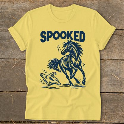 Yellow t-shirt with navy blue "SPOOKED" text and a startled horse and ghost graphic.