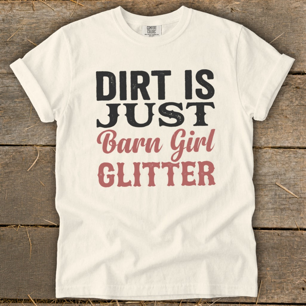Cream t-shirt with "DIRT IS JUST Barn Girl GLITTER" text in black and pink.